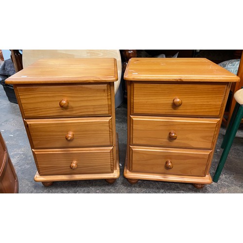 65 - PAIR OF PINE THREE DRAWER BEDSIDE CHESTS