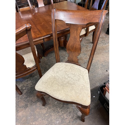 144 - DARK WALNUT TWIN PEDESTAL EXTENDING DINING TABLE AND SIX SCROLL BACK CHAIRS