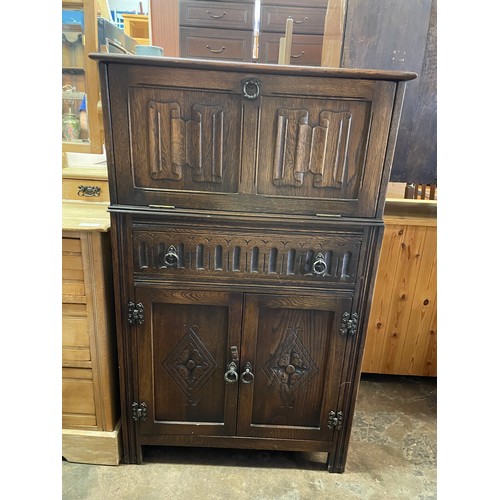 134 - CARVED OAK LINENFOLD DRINKS CABINET