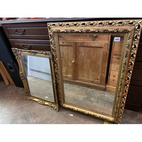 103 - TWO GILT SWEPT FRAMED MIRRORS