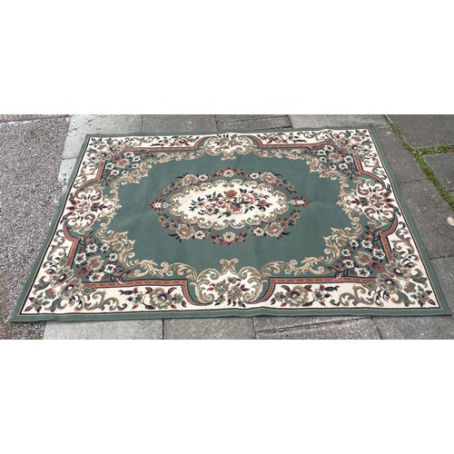 75A - LARGE GREEN RUG WITH FLORAL BORDER AND CENTRE PIECE 160cm x 230cm