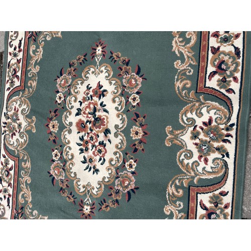 75A - LARGE GREEN RUG WITH FLORAL BORDER AND CENTRE PIECE 160cm x 230cm