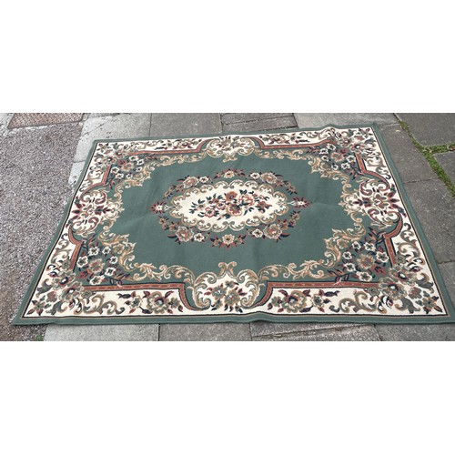 75A - LARGE GREEN RUG WITH FLORAL BORDER AND CENTRE PIECE 160cm x 230cm