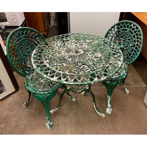 114 - VICTORIAN STYLE CAST METAL CIRCULAR PATIO TABLE AND TWO OVAL BACKED CHAIRS