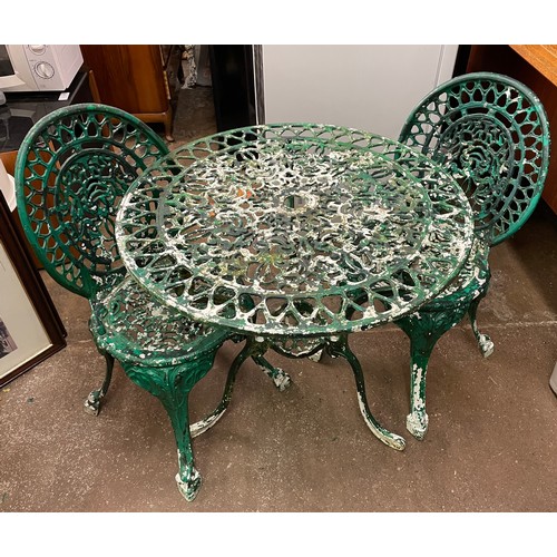 114 - VICTORIAN STYLE CAST METAL CIRCULAR PATIO TABLE AND TWO OVAL BACKED CHAIRS