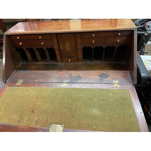 77 - GEORGE III MAHOGANY BUREAU THE FALL FLAP ENCLOSING A FITTED INTERIOR WITH LOPPERS AND FOUR GRADUATED... 