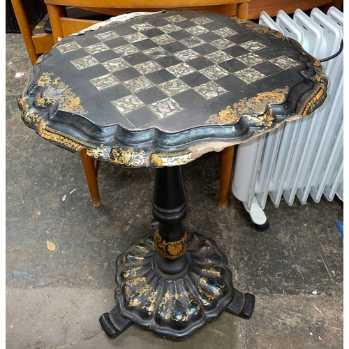 110A - BLACK LACQUERED PAPIER MACHE TILT TOP CHESS TABLE WITH ABALONE BOARD AND GILT BORDER A/F