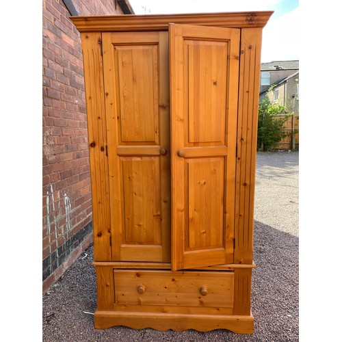 214 - PINE PANELLED TWO DOOR WARDROBE WITH SINGLE BASE DRAWER