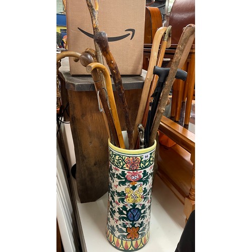 94 - POTTERY CYLINDRICAL STICK STAND OF VARIOUS WALKING CANES AND STICKS