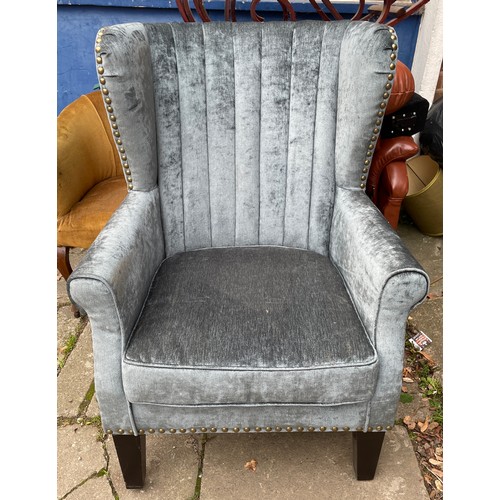 76 - SILVERED STUDDED UPHOLSTERED WING ARMCHAIR