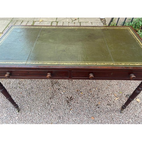 129 - VICTORIAN MAHOGANY WRITING TABLE WITH INSET GREEN LEATHER SCIVER ON RING TURNED TAPERED LEGS