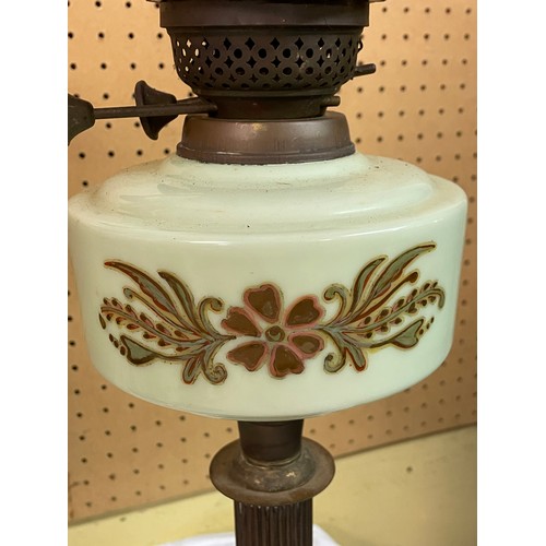 247 - OIL LAMP WITH OPAQUE SHADE AND A TRANSFER PRINTED GREEN RESERVOIR ON A FLUTED EMBOSSED BASE