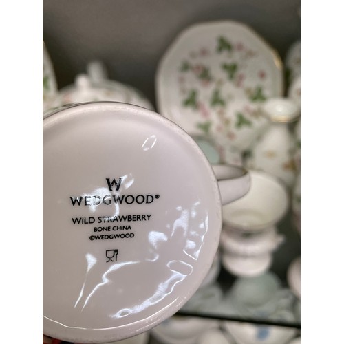 293 - SHELF OF WEDGWOOD WILD STRAWBERRY PATTERN TABLEWARE, VASES, JARS AND COVERS, TEAPOT