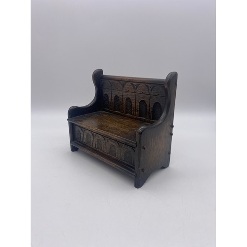 432 - MINIATURE MUSICAL CARVED OAK SETTLE BOX