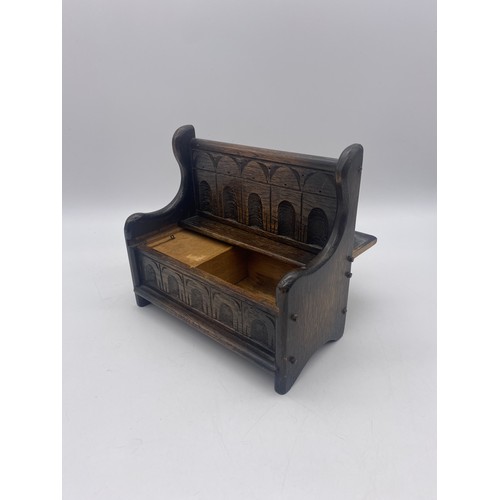 432 - MINIATURE MUSICAL CARVED OAK SETTLE BOX