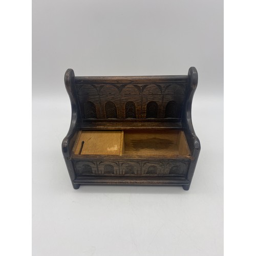 432 - MINIATURE MUSICAL CARVED OAK SETTLE BOX