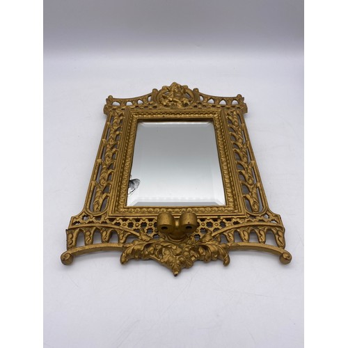 484 - GILT METAL CHERUB MOUNTED MIRROR WITH CANDLE BRANCHES MISSING A/F