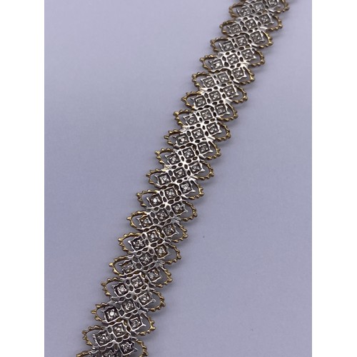 513 - 9CT GOLD AND WHITE GOLD FILIGREE BRACELET WITH DIAMOND CHIP CENTRES AND SAFETY CLASP 12.9G APPROX