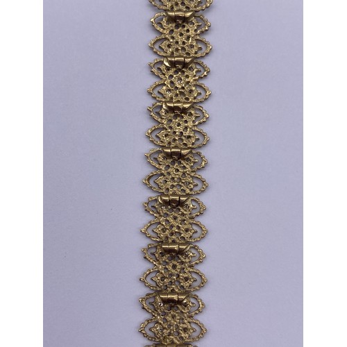 513 - 9CT GOLD AND WHITE GOLD FILIGREE BRACELET WITH DIAMOND CHIP CENTRES AND SAFETY CLASP 12.9G APPROX