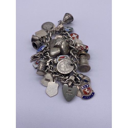 527 - SILVER CHARM BRACELET WITH HEART PADLOCK AND FASTENER, VARIOUS SILVER AND WHITE METAL CHARMS 2OZ APP... 