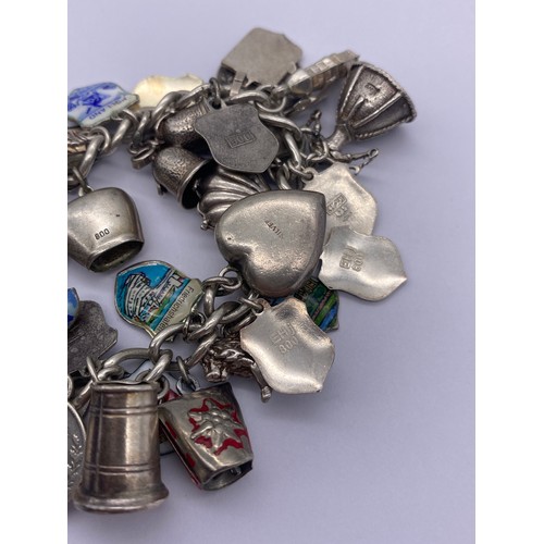 527 - SILVER CHARM BRACELET WITH HEART PADLOCK AND FASTENER, VARIOUS SILVER AND WHITE METAL CHARMS 2OZ APP... 