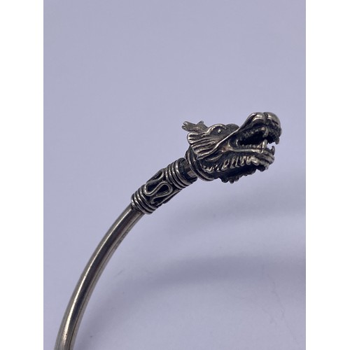 526 - SHIPTON AND CO DOUBLE DRAGON HEAD BANGLE AND A DECORATIVE COSTUME DRAGON BROOCH