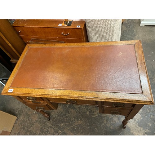 131 - EDWARDIAN OAK AND WALNUT FRONTED KNEEHOLE WRITING TABLE