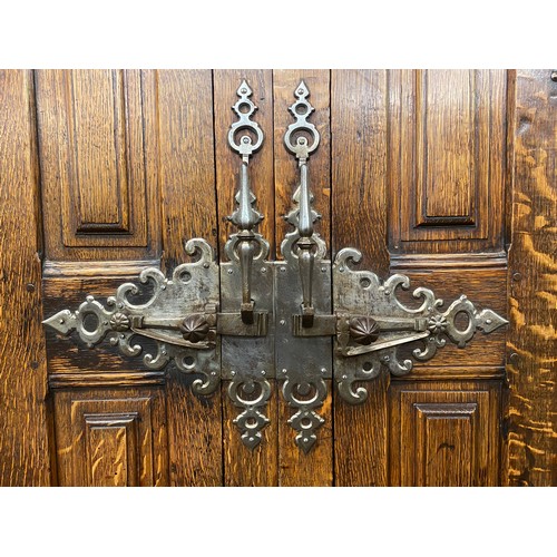 132 - 19TH CENTURY OAK BLOCK PANELLED FRONT CABINET WITH GERMAN STYLE IRON WORK LOCK