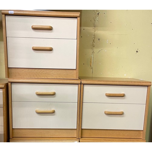 69 - THREE LIGHT BEECH AND CREAM TWO DRAWER BEDSIDE CHESTS