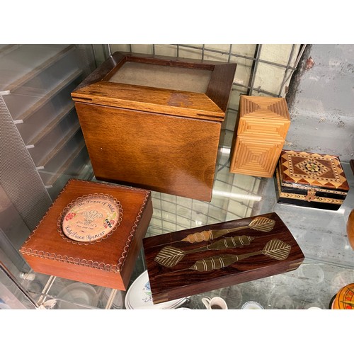 287 - SHELF OF CARVED WOODEN BOXES, ORNAMENTAL TURNED FRUIT, STRAW WORK BOX, AND CASHS SILK BOX