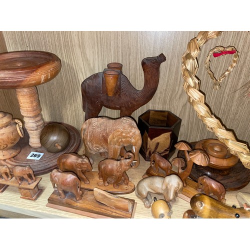 269 - SHELF OF CARVED ANIMAL ORNAMENTS, MAINLY ELEPHANTS, TURNED WOODEN BOWL AND FRUIT