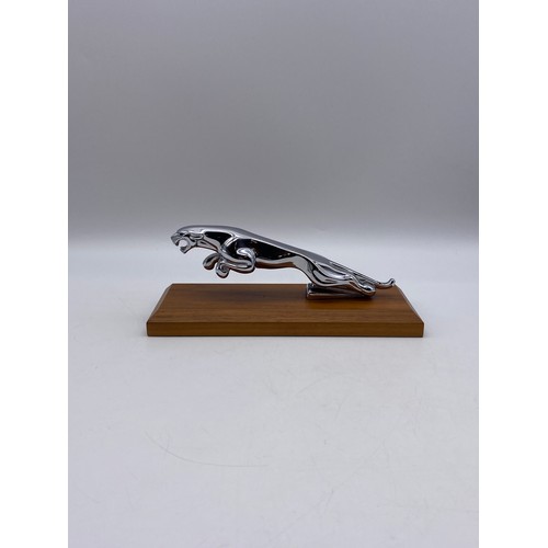 487 - JAGUAR CAR LEAPING CAR BONNET MASCOT ON WOODEN PLINTH