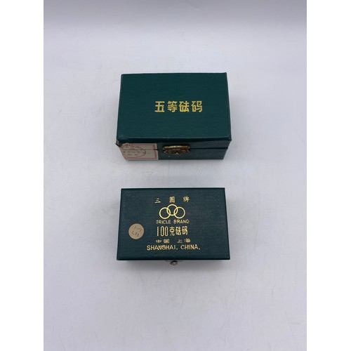 491 - CHINESE CASED SET OF MINIATURE WEIGHTS UP TO 50GRAMS AND ONE OTHER SET UP TO 100GRAMS