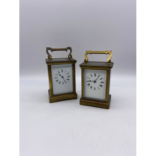 550 - TWO SIMILAR BRASS LAQUERED CARRIAGE CLOCKS WITH ANGULAR HANDLES