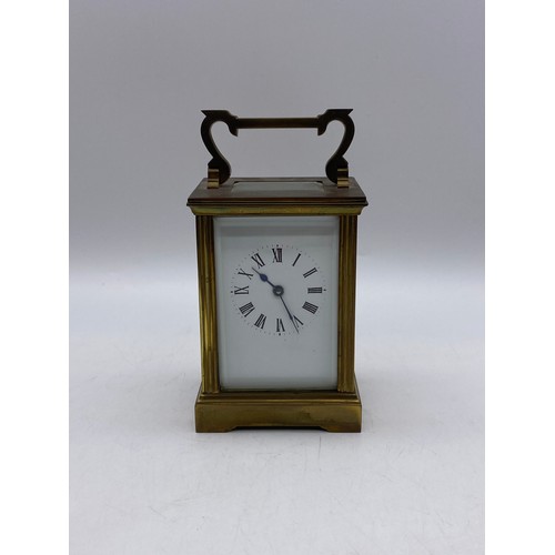 550 - TWO SIMILAR BRASS LAQUERED CARRIAGE CLOCKS WITH ANGULAR HANDLES