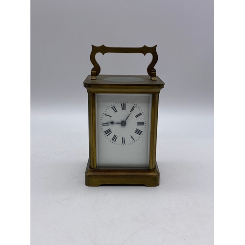 550 - TWO SIMILAR BRASS LAQUERED CARRIAGE CLOCKS WITH ANGULAR HANDLES