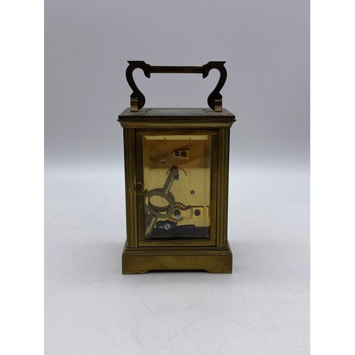 550 - TWO SIMILAR BRASS LAQUERED CARRIAGE CLOCKS WITH ANGULAR HANDLES