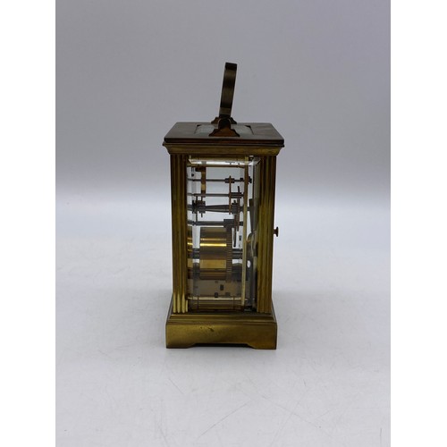 550 - TWO SIMILAR BRASS LAQUERED CARRIAGE CLOCKS WITH ANGULAR HANDLES