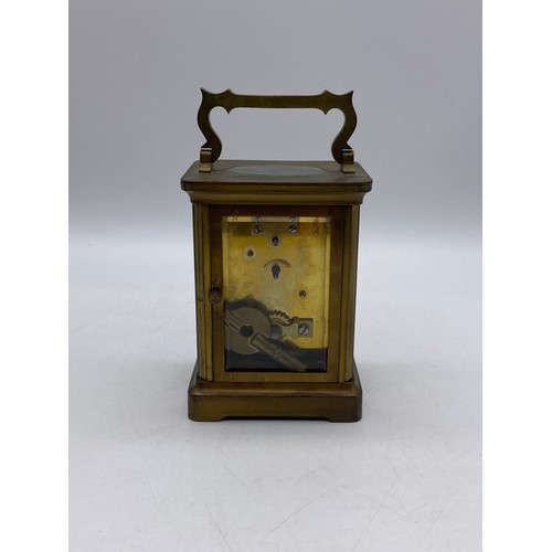 550 - TWO SIMILAR BRASS LAQUERED CARRIAGE CLOCKS WITH ANGULAR HANDLES