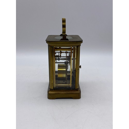 550 - TWO SIMILAR BRASS LAQUERED CARRIAGE CLOCKS WITH ANGULAR HANDLES