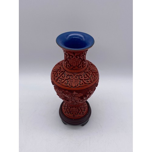 551 - RED CINNABAR LACQUER CARVED BALUSTER VASE ON A HARD WOOD STAND