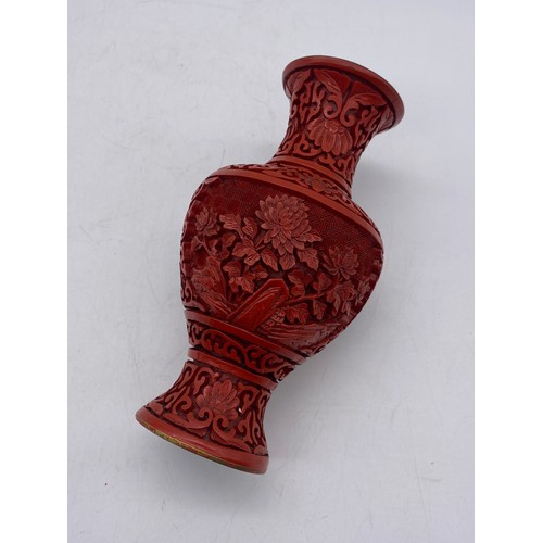 551 - RED CINNABAR LACQUER CARVED BALUSTER VASE ON A HARD WOOD STAND