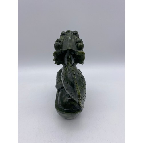 524 - CHINESE CARVED GREEN SOAP STONE DRAGON ON ROCK FIGURE