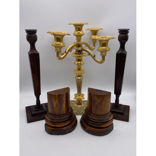 528 - PAIR OF CHIP CARVED TAPERED CANDLE STICKS, PAIR OF WOODEN BOOKENDS, AND GILDED FIVE BRANCH CANDELABR... 