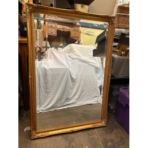 211 - GILT SWEPT FRAMED BEVELLED MIRROR