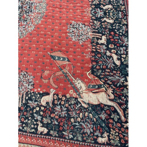 39 - TERRACOTTA FRINGED TAPESTRY WALL HANGING DEPICTING UNICORNS AND DEER 134CM X 134CM