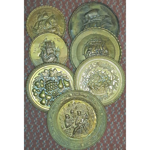 314 - SHELF OF MAINLY BRASS EMBOSSED WALL PLAQUES, VINTAGE BRASS DOOR KNOBS, AND SIFTER