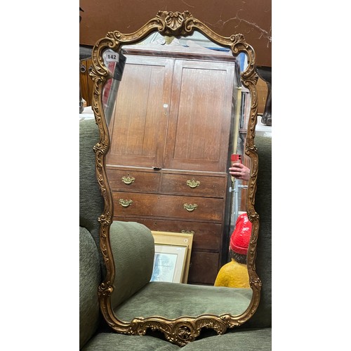 142 - GILT SHELL SCROLLED MIRROR 94CM X 45CM