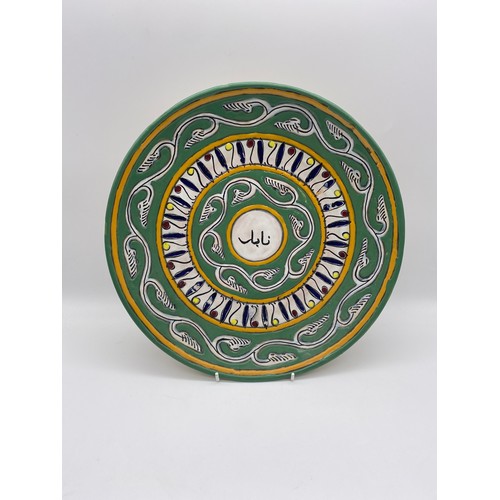 650 - PAIR OF MID CENTURY IRANIAN POTTERY DECORATED WALL PLATES (ONE A/F)