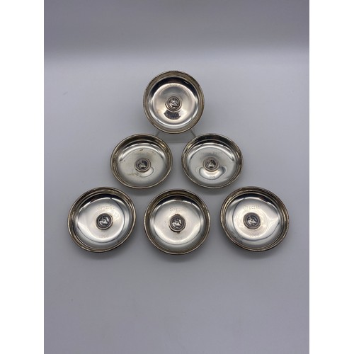 599 - SET OF SIX LONDON SILVER SMALL DISHES CENTRED WITH A CATTLE PLAQUE INSCRIBED 1965-1966 9.6OZ APPROX